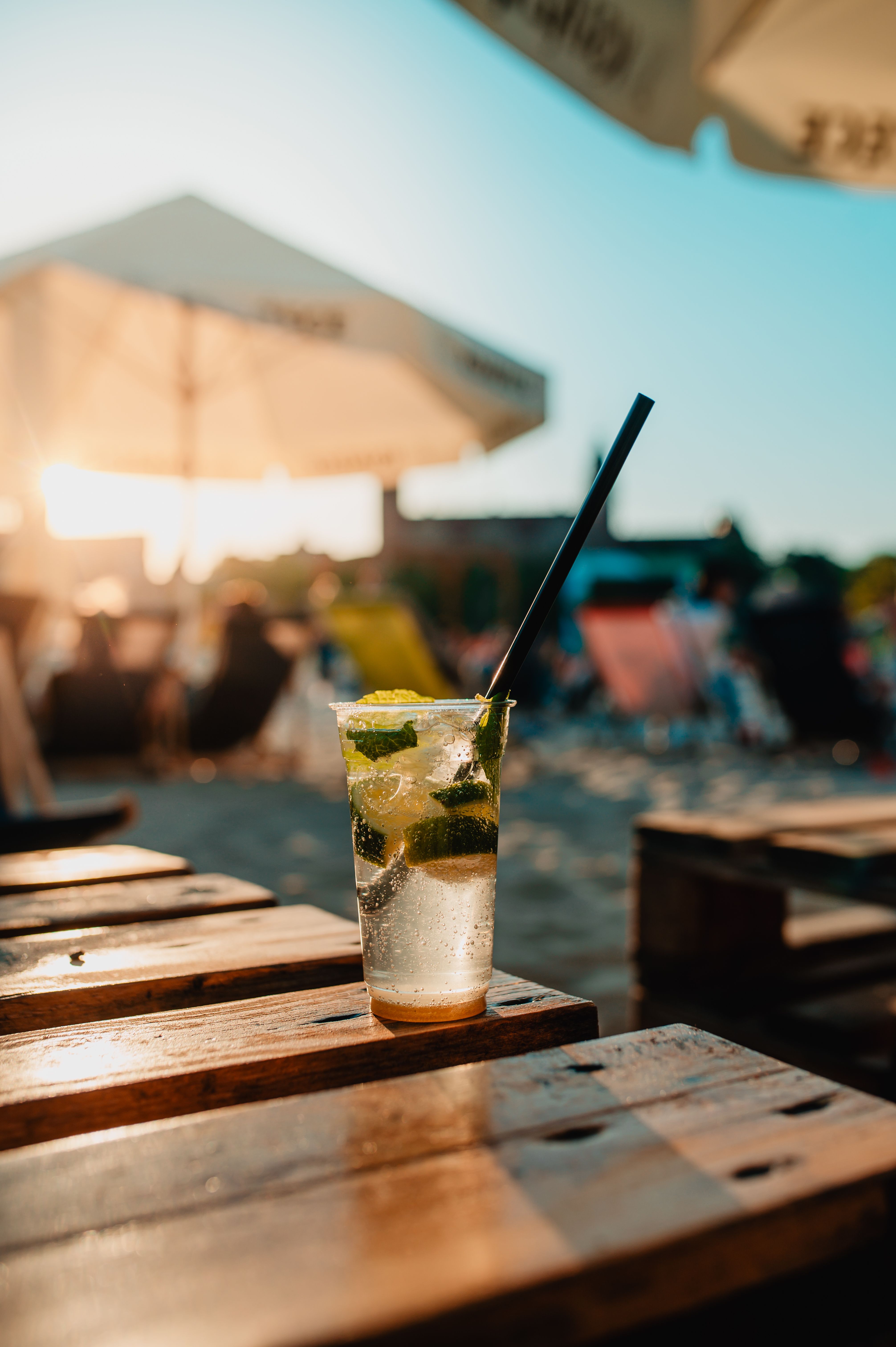 A crisp cocktail sits on a table at a vibrant beach setting in Szczecin, Poland.