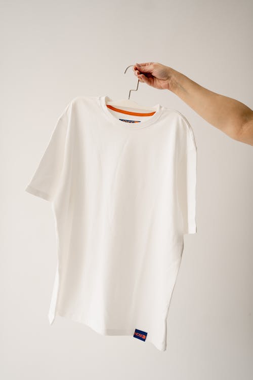 Hand Holds Hanger with T-shirt