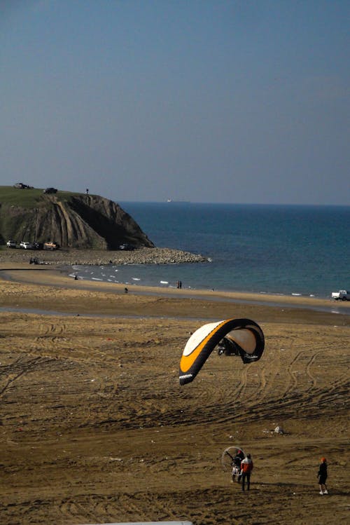 A person is flying a kite on a beach