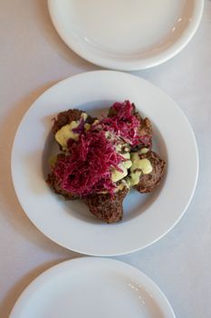 Close-up of a gourmet dish with vegetables and sauce served in Buenos Aires.