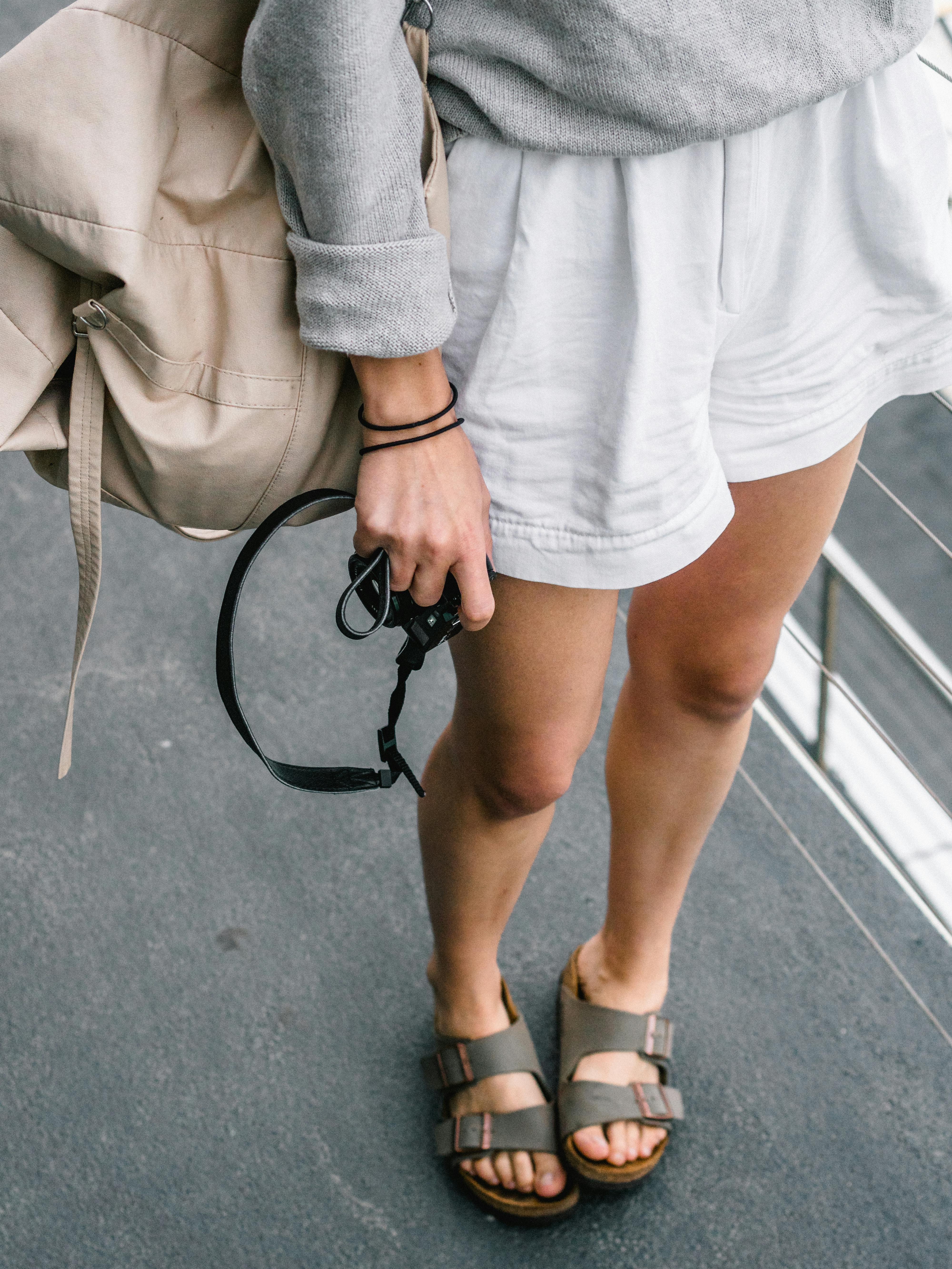 Woman at Bondi Beach wearing casual sandals, capturing the essence of a summer day.