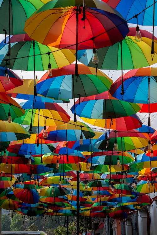 A bunch of colorful umbrellas hanging from the ceiling