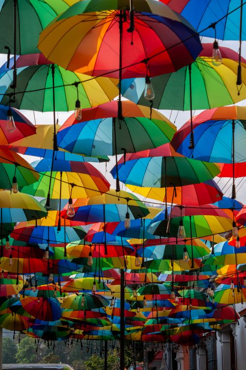 Free Colorful umbrellas hanging in an urban alleyway in Mérida, Venezuela. Stock Photo