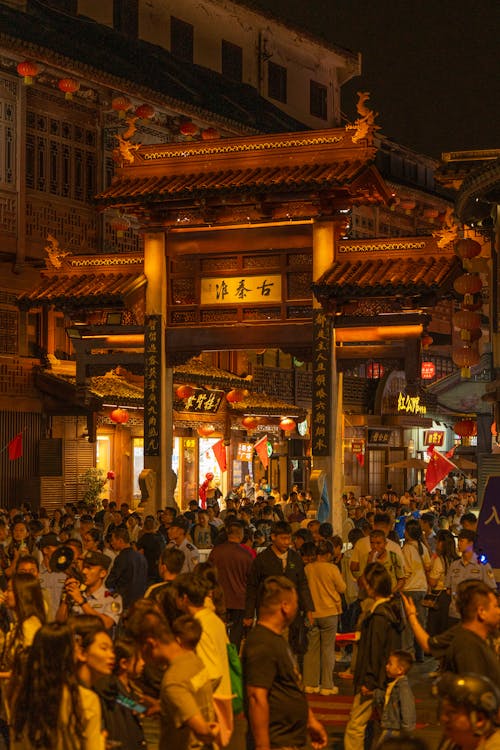 A crowded street with people walking around