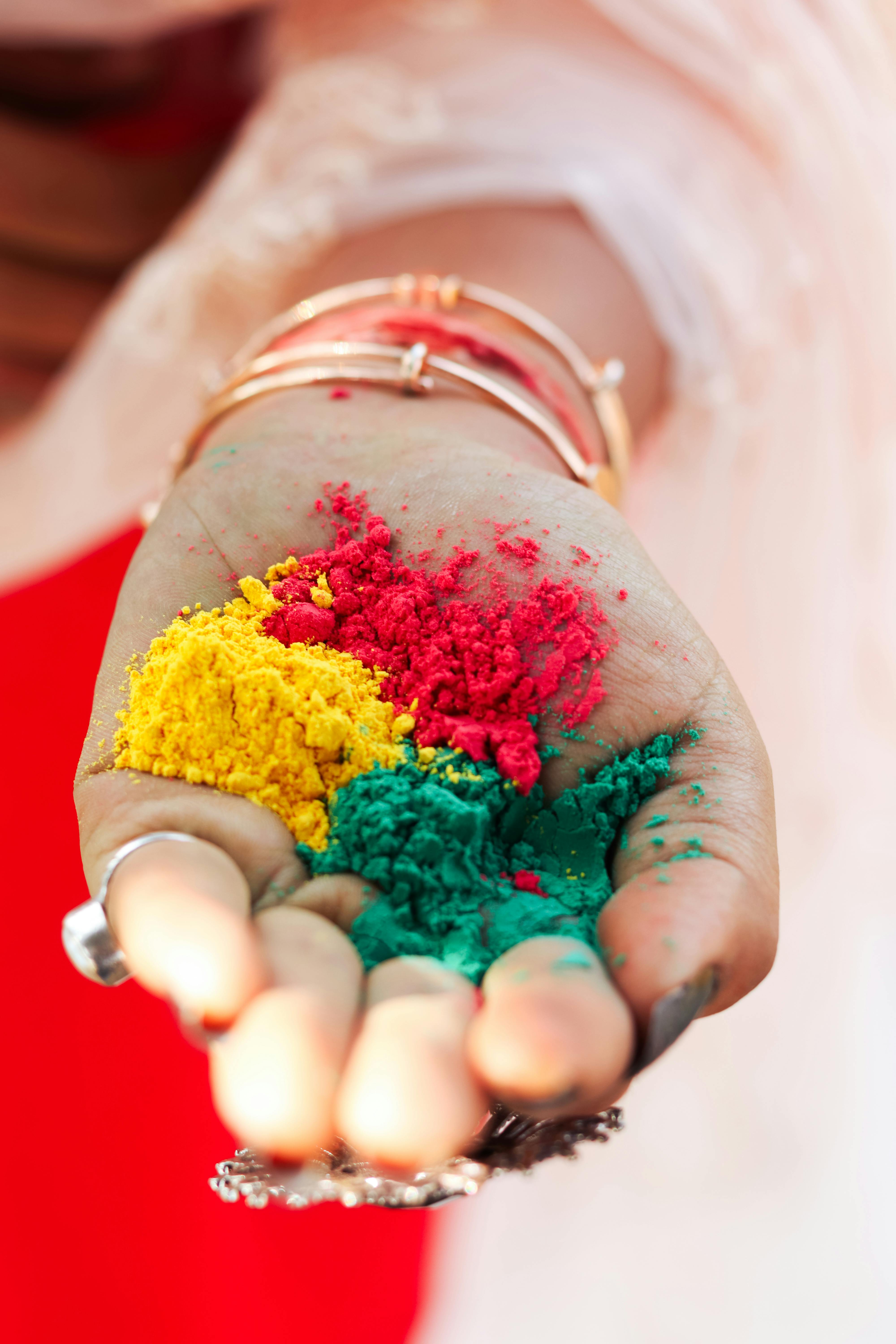 woman hand holding colorful powder