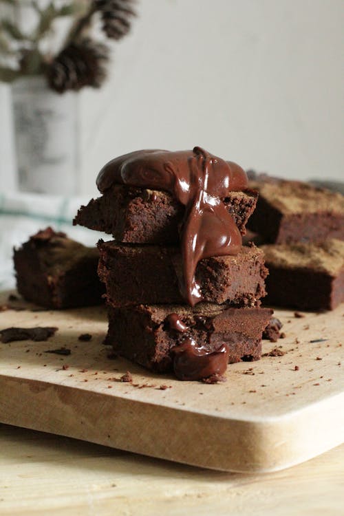 Free Close-Up Photo Of Stacked Brownies On Chopping Board Stock Photo