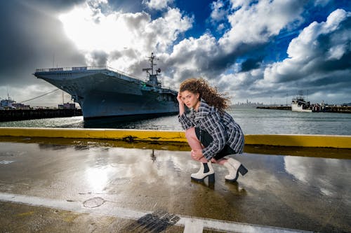 Young Woman Kneeling Shipyard Dock Rainy Day Back Light