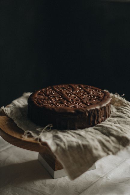 Delicious chocolate cake placed on rustic linen, ideal for dessert photography.