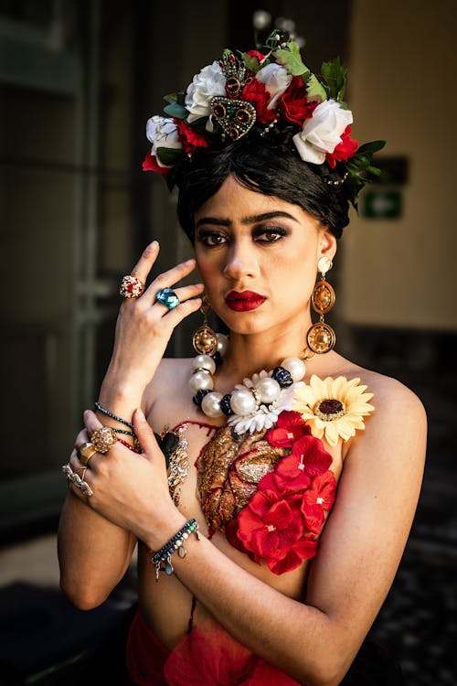 A woman in a frida dress with flowers on her head