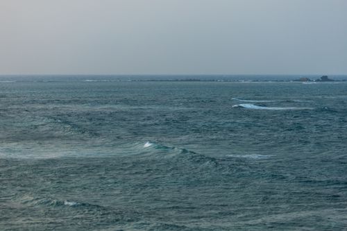 Free A calm sea stretching towards a distant horizon, capturing tranquility and vastness of the ocean. Stock Photo