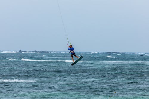 A person is kite boarding in the ocean