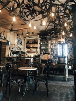Warm and inviting modern coffee shop interior with unique lighting and wooden elements.