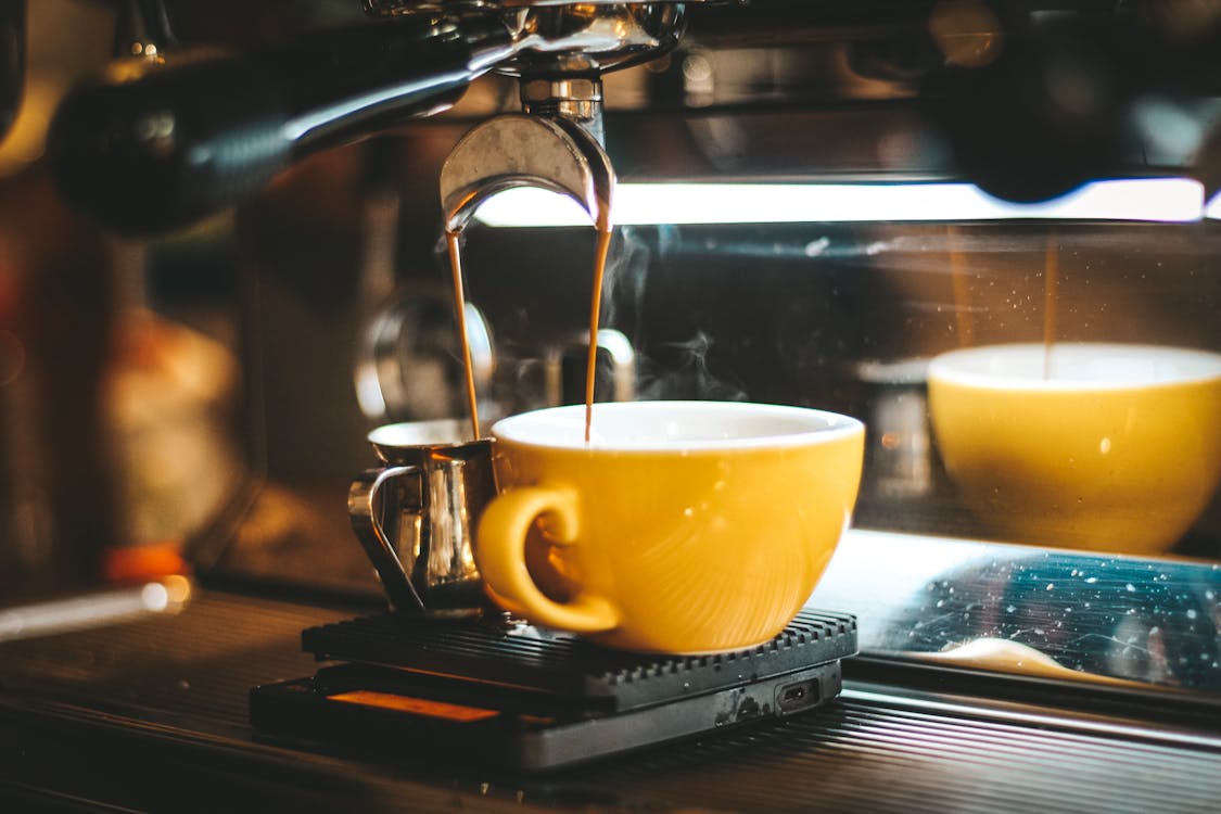 Free Espresso Machine Dispensing on Two Mugs Stock Photo