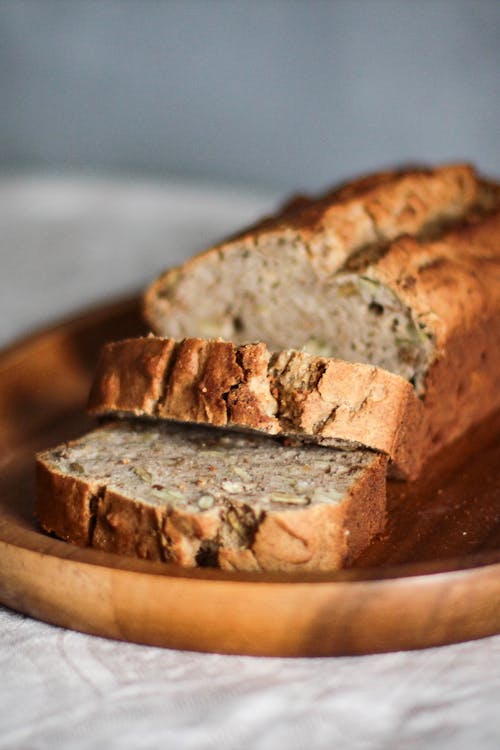 Close-up Photo of Sliced Brown Bread on Brown Wooden Tray