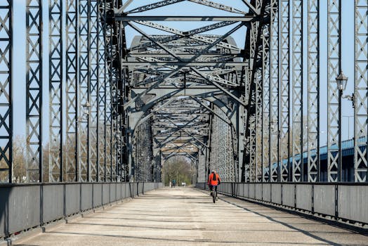 A cyclist rides across the steel Alte Harburger Elbbrücke in Hamburg, Germany.