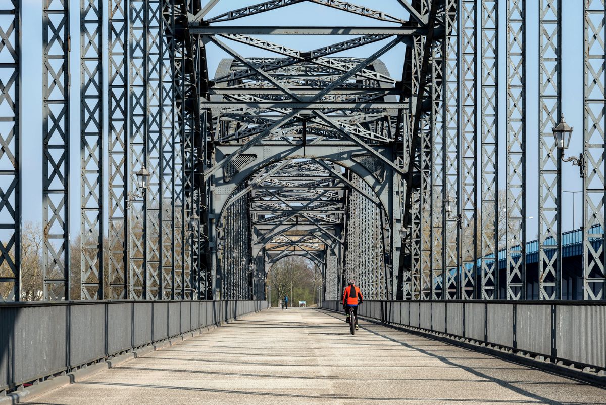Cyclist riding along a bridge with sea views in clear weather