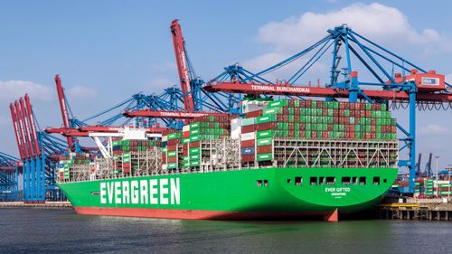 Free Evergreen container ship moored at Burchardkai Terminal, Hamburg harbor, Germany. Stock Photo