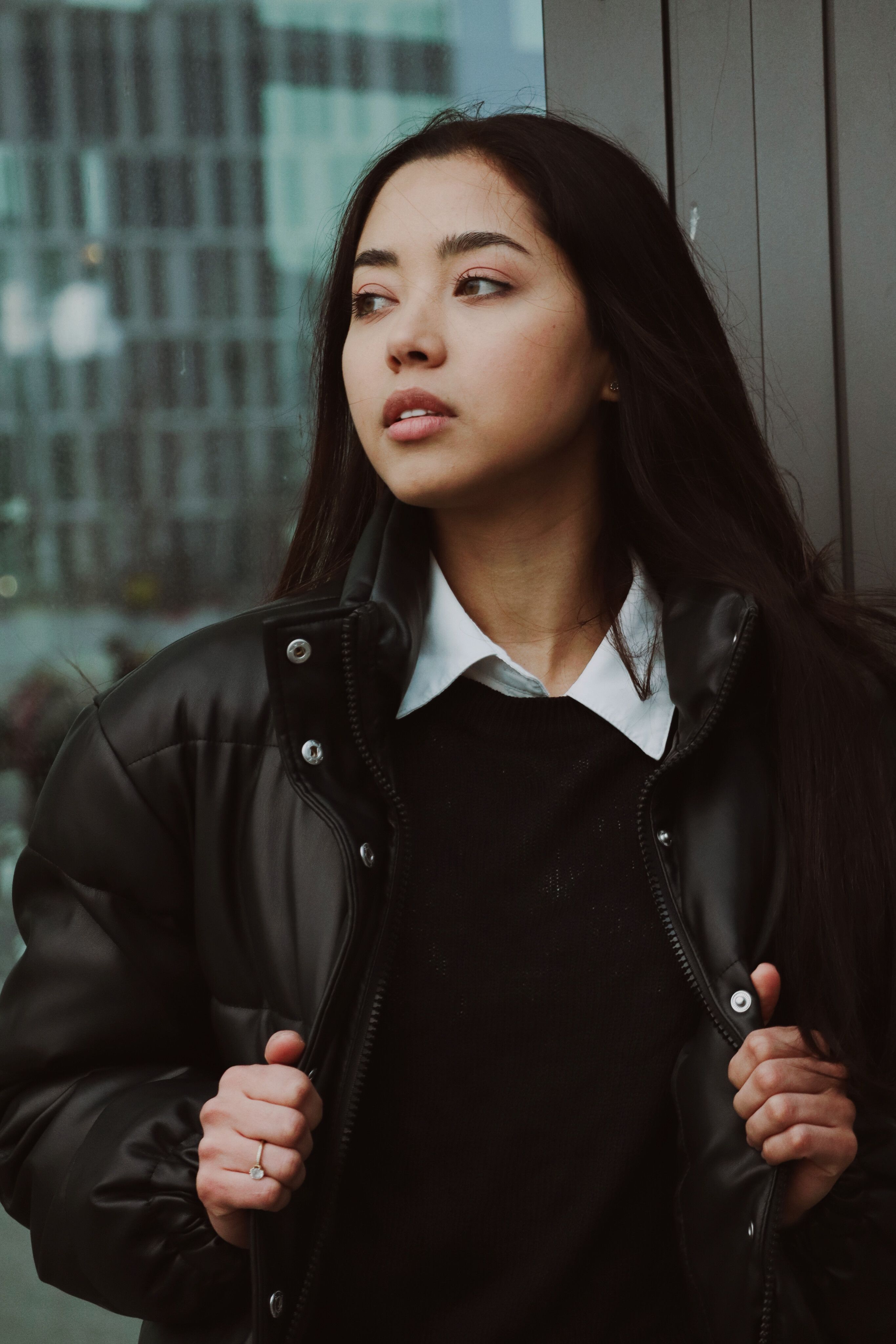 Young Woman in a Jacket Standing near a Building in City · Free Stock Photo