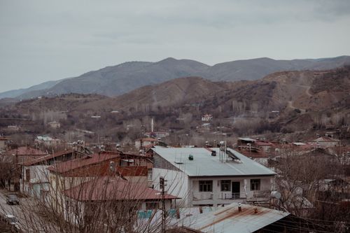 Free Charming townscape of Palu, Elazığ with mountains in the backdrop on a cloudy day. Stock Photo