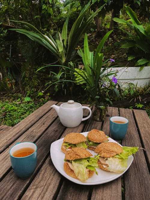 A table with sandwiches and tea on it
