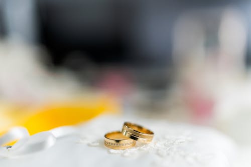 Two wedding rings on a white table