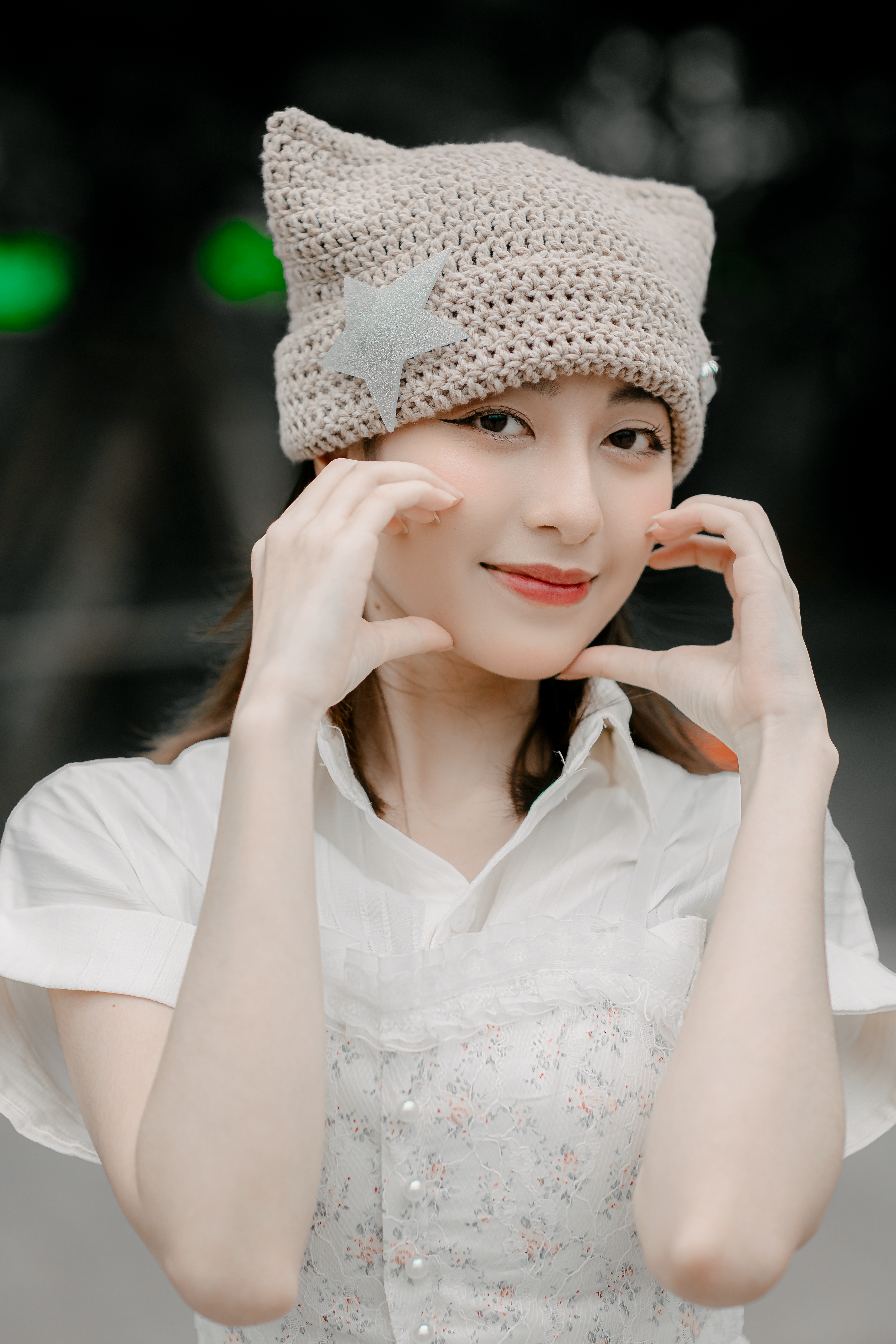 Charming portrait of a smiling woman in a crochet hat posing stylishly.