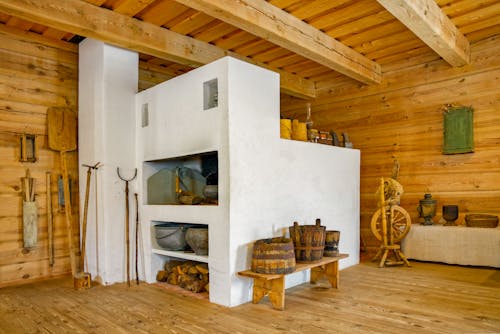 A wooden cabin with a fireplace and a stove