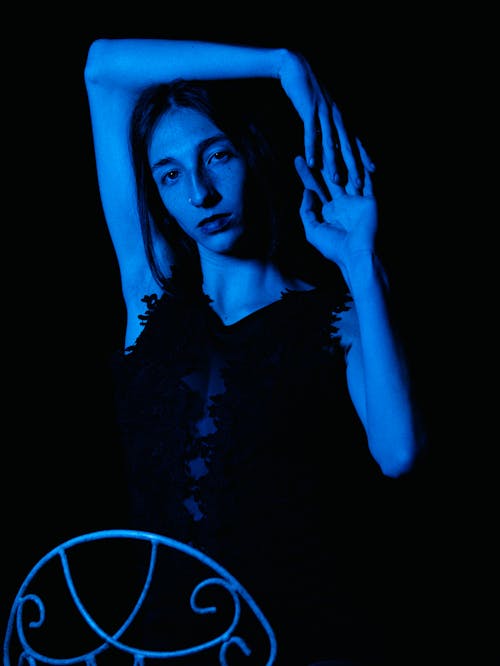 Fashion model posing in blue lighting 