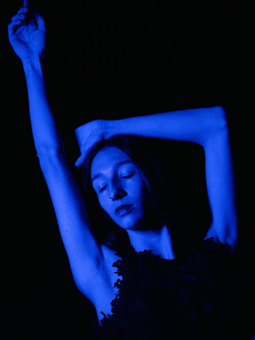 Woman posing in blue lighting 