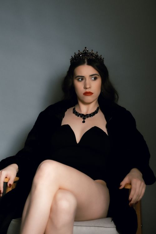 Free Stylish portrait of a woman in a black outfit and crown exuding confidence. Stock Photo