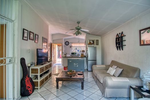 Inviting interior view of a stylish living room connected to a kitchen, Pretoria.