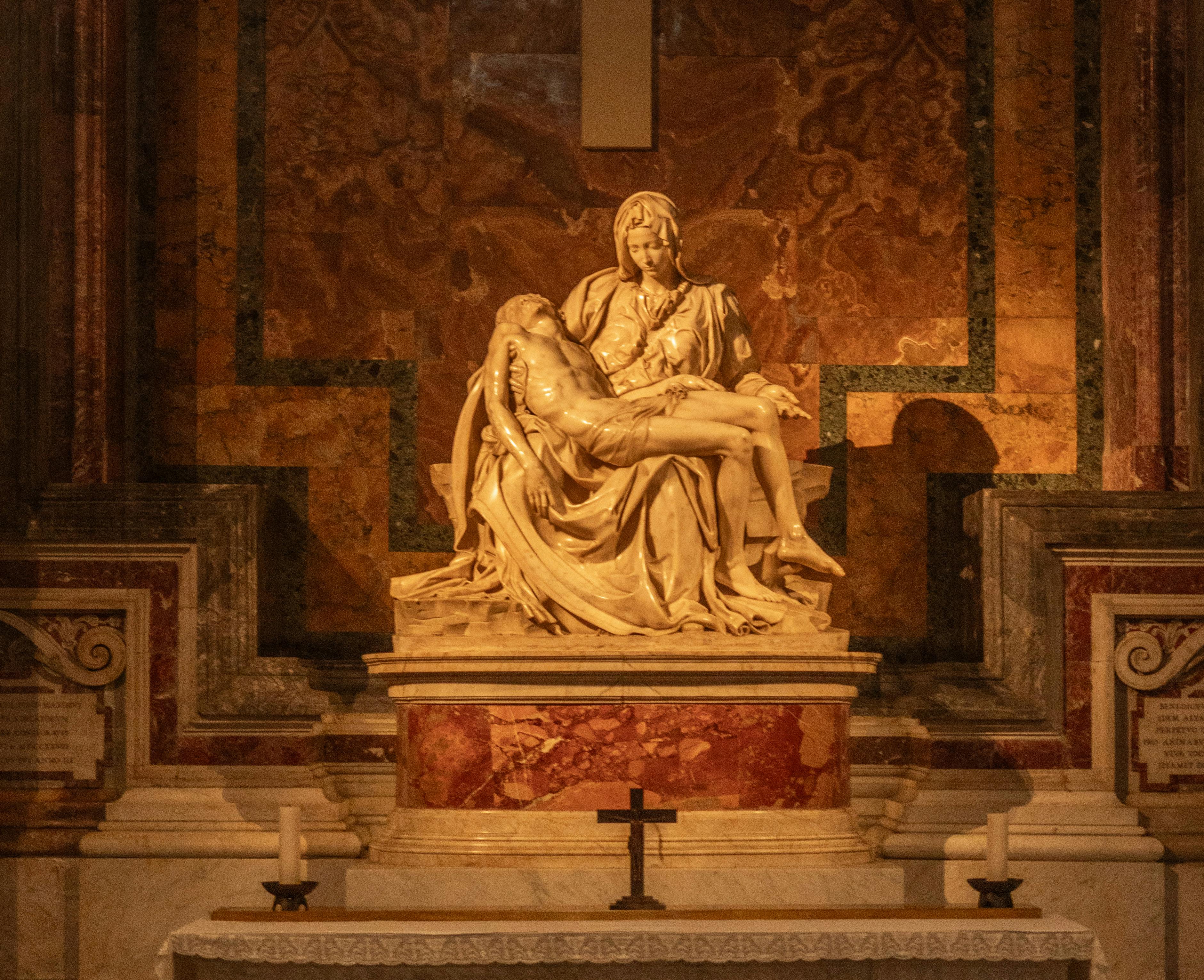 Marble sculpture of Virgin Mary holding Christ, created by Michelangelo in Vatican City.