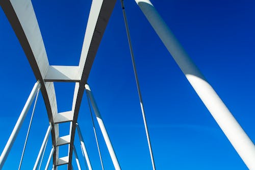 A white bridge with blue sky in the background