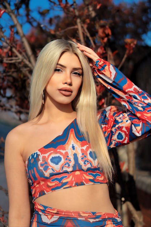 A beautiful blonde woman in a blue and red patterned top