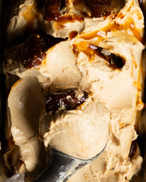 A scoop of ice cream with caramel and nuts