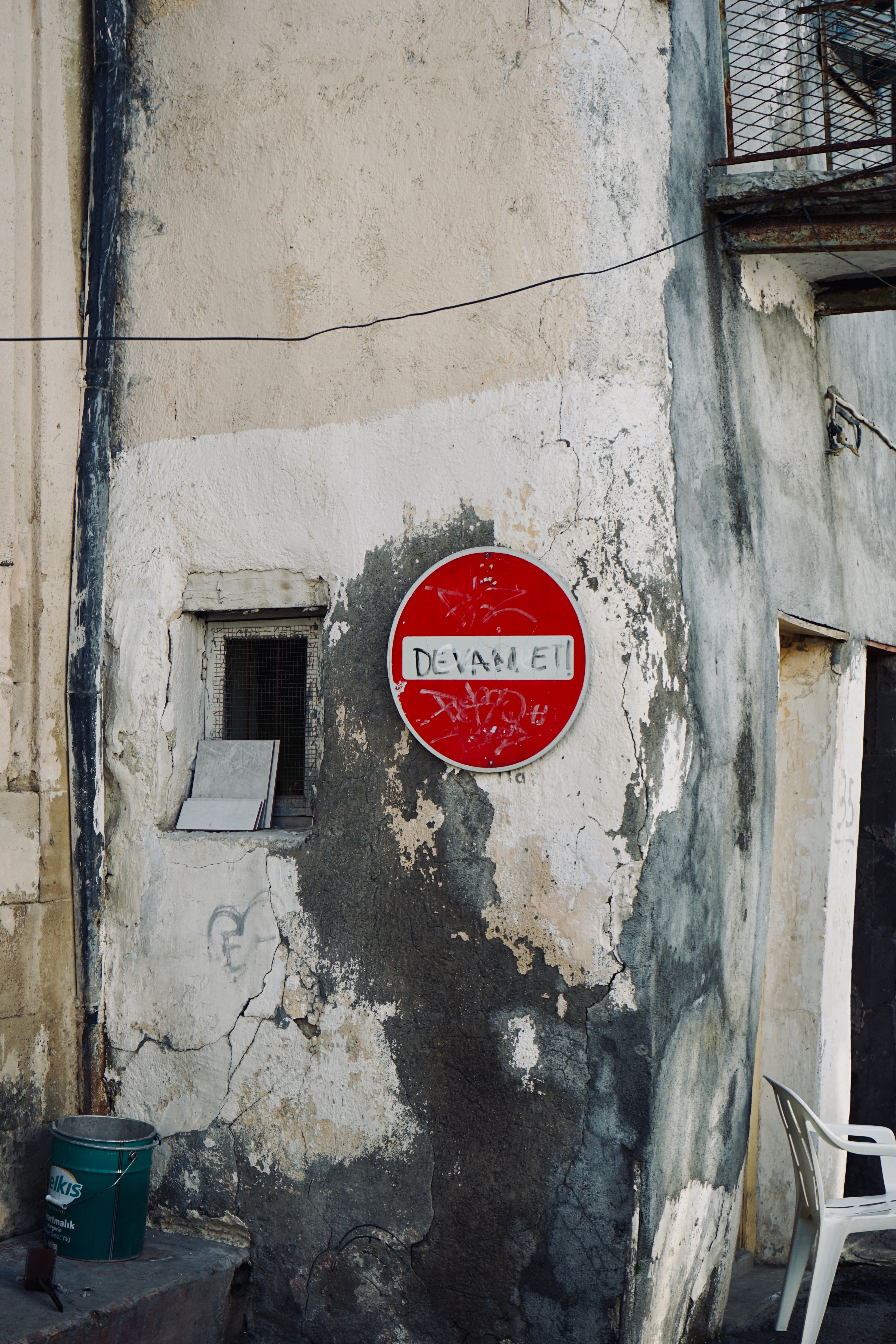 Stop Sign on Abandoned Building Wall · Free Stock Photo