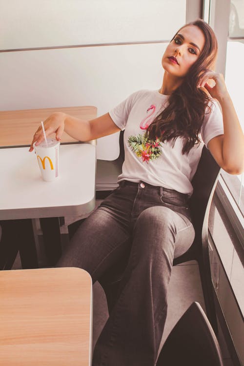 Free Woman Sitting Down Holding Mcdonald's Cup Stock Photo