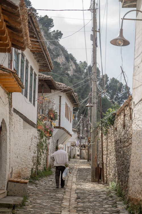 Elderly Man Walking in a Narrow Alley in Albania 