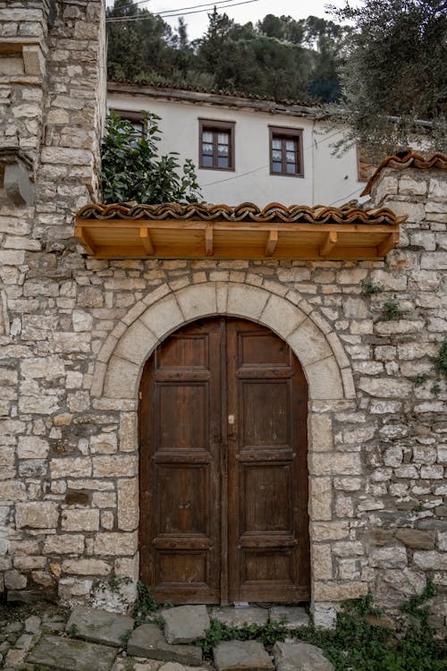 A wooden door is in front of a stone building