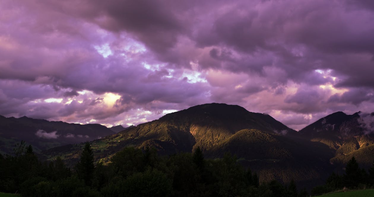 Brown Mountain Under Cloudy Sky During Sunset · Free Stock Photo
