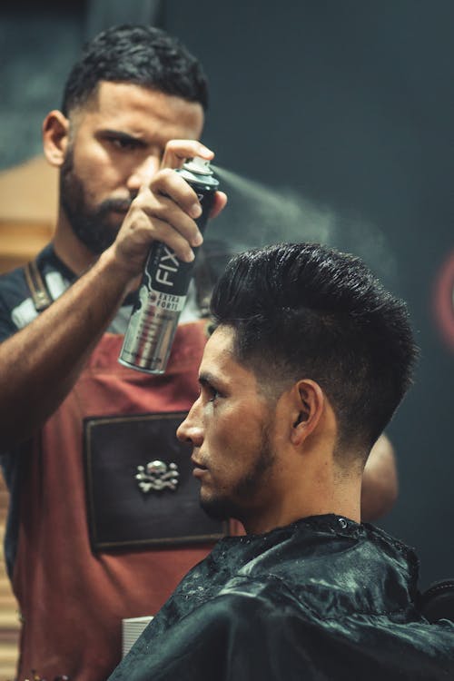 Free Barber Using Hair Spray Stock Photo