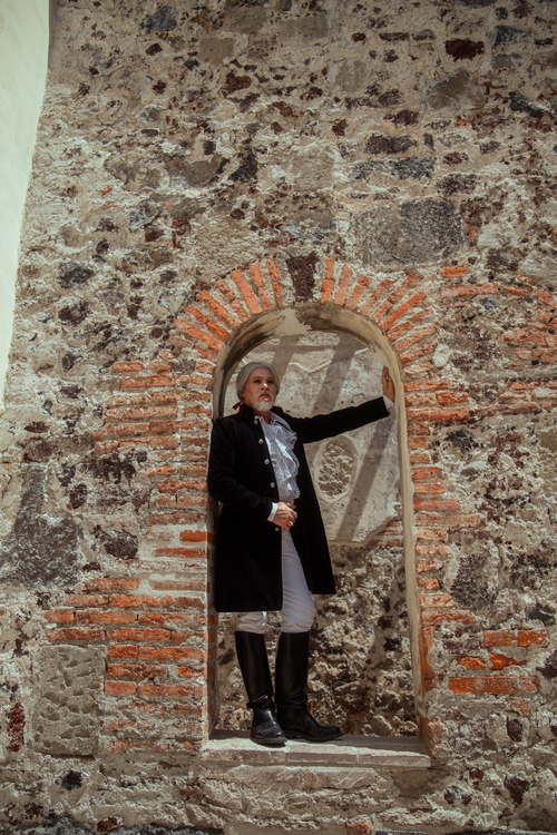 Free An elegantly dressed man poses in historical Mexican architecture in Ciudad de México. Stock Photo