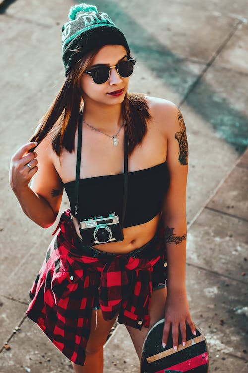 Confident trendy female hipster on street · Free Stock Photo
