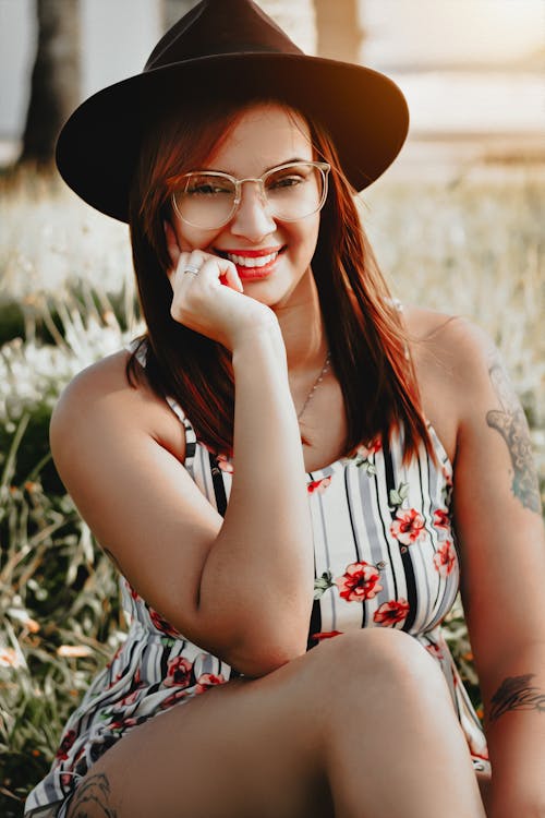 Woman Wearing White-and-black Striped Floral Tank Top and Black Hat