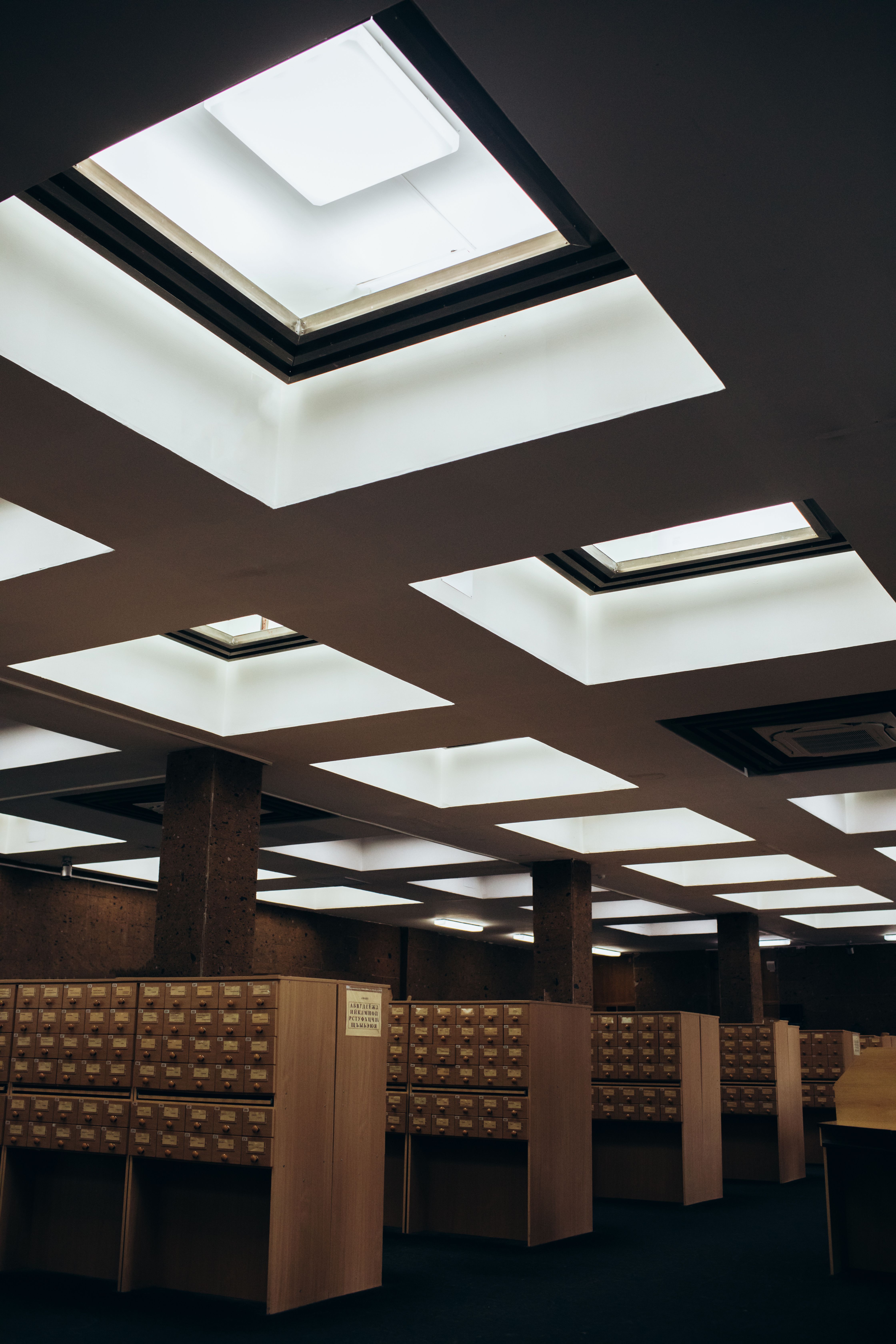 A library card catalog with organized wooden drawers
