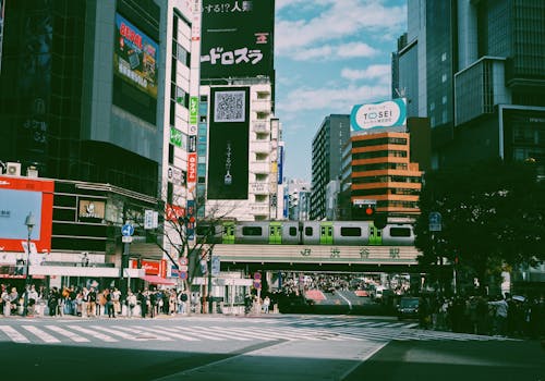 Bustling scene at Shibuya Crossing featuring modern architecture and iconic city life in Tokyo.