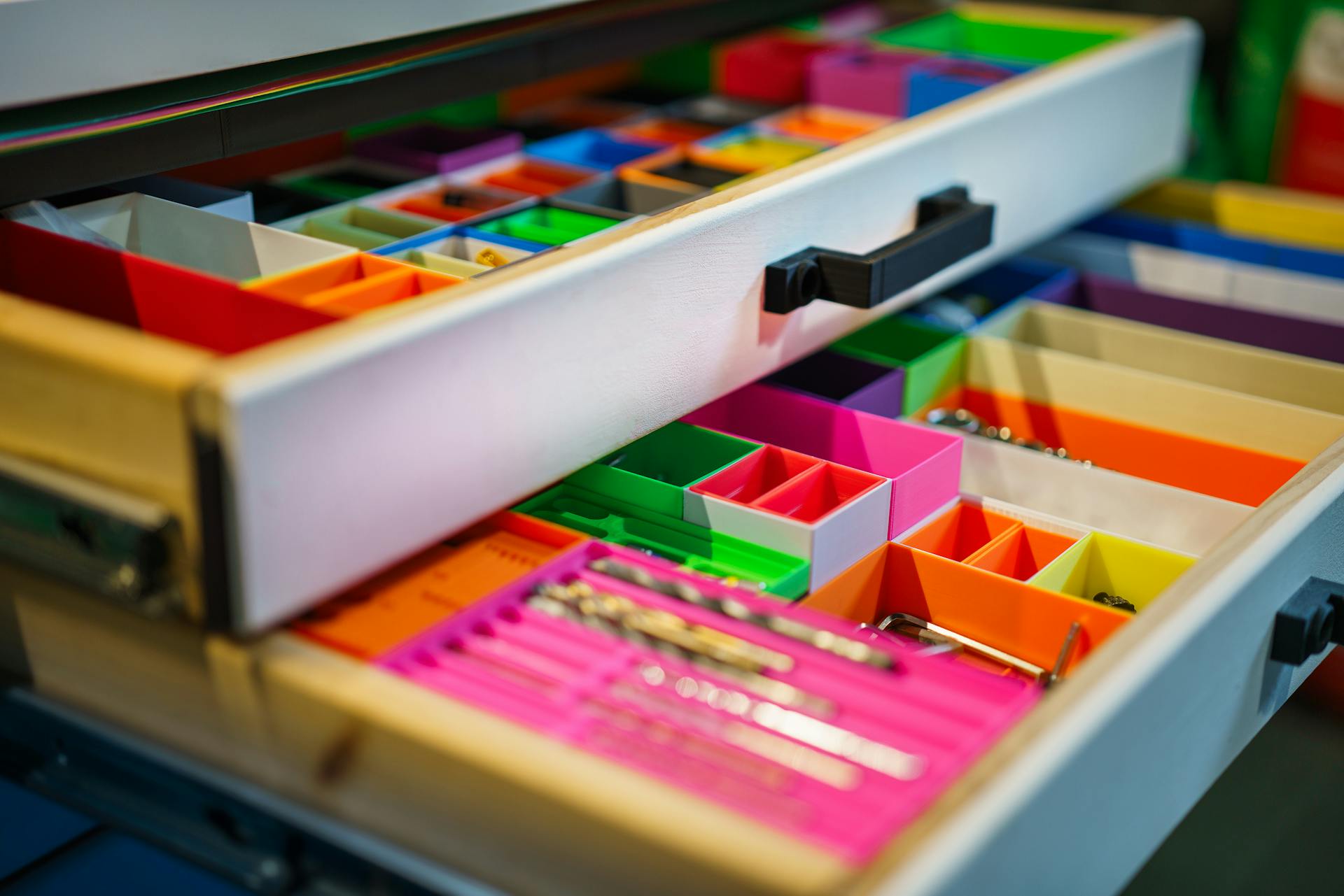 A neatly arranged drawer featuring vibrant colored compartments for efficient organization.