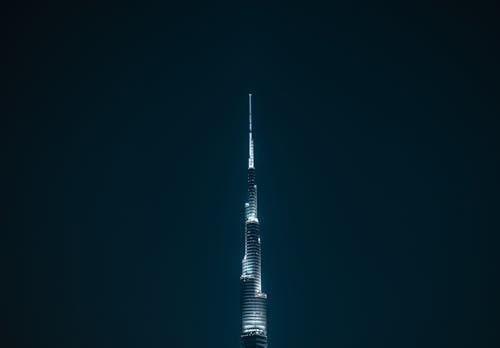 The burj khalifa tower is lit up at night