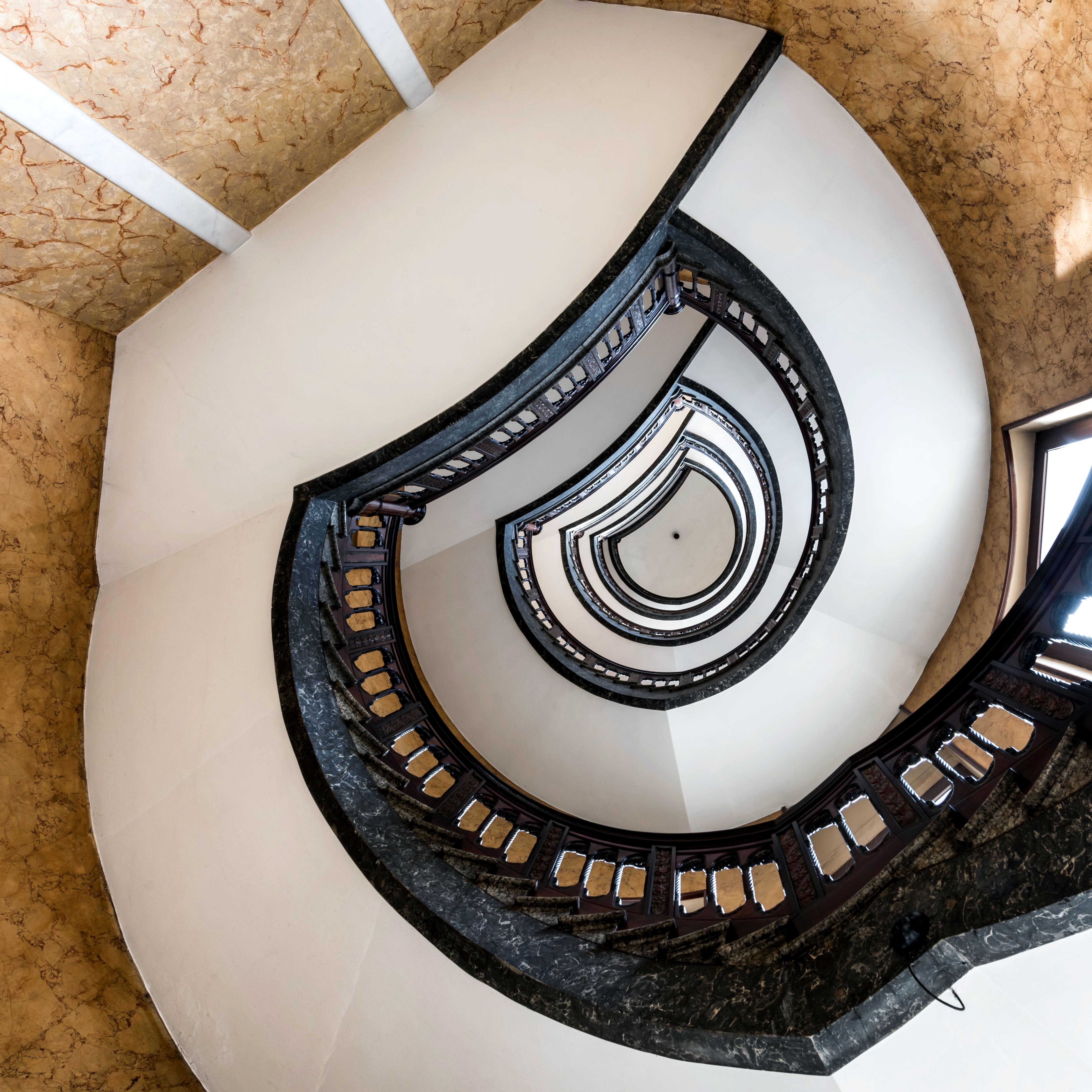 Elegant spiral staircase in Hamburg, showcasing architectural beauty and artistic perspective.