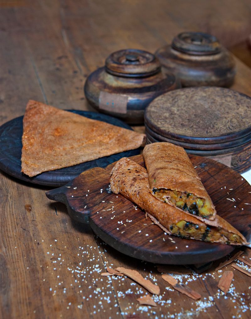 Indian dosa served with chutney on a rustic platter
